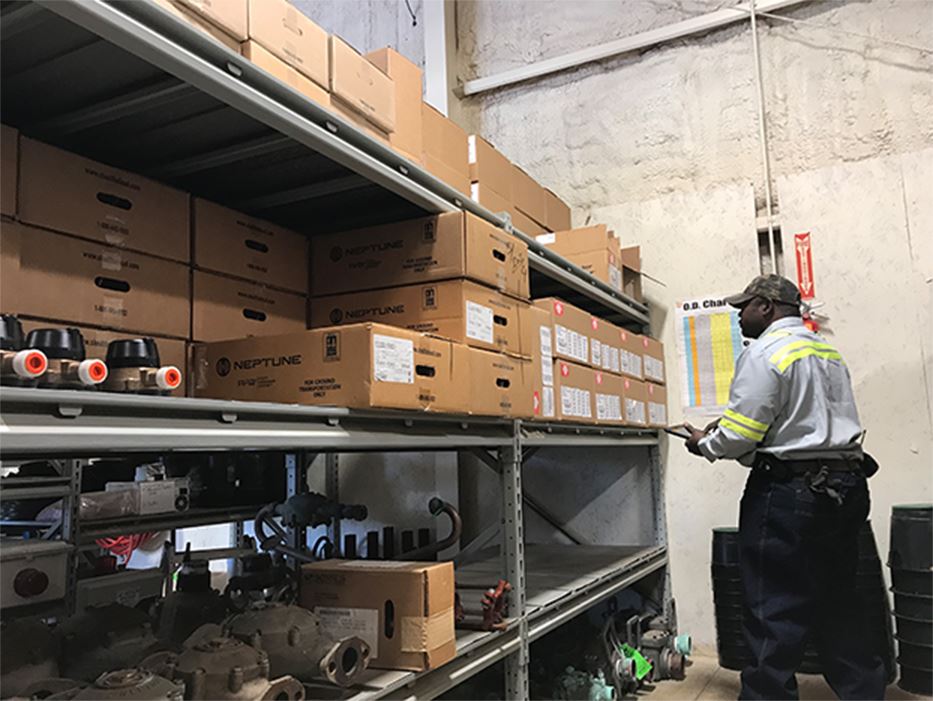 Utility Employee Looking at Boxes in a Warehouse